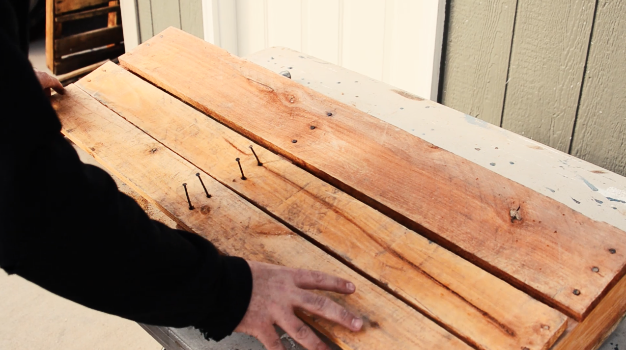 Fill in the empty spaces on the back of the shelf with extra panels from the pallet.