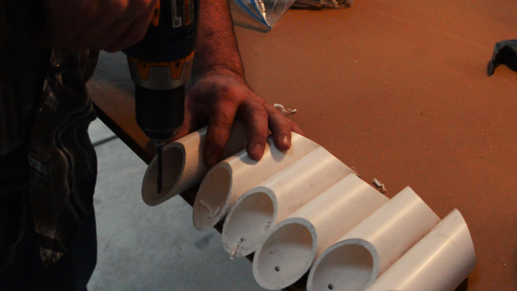 Predrill holes in open ends the PVC pipe where it will be attached to the board.