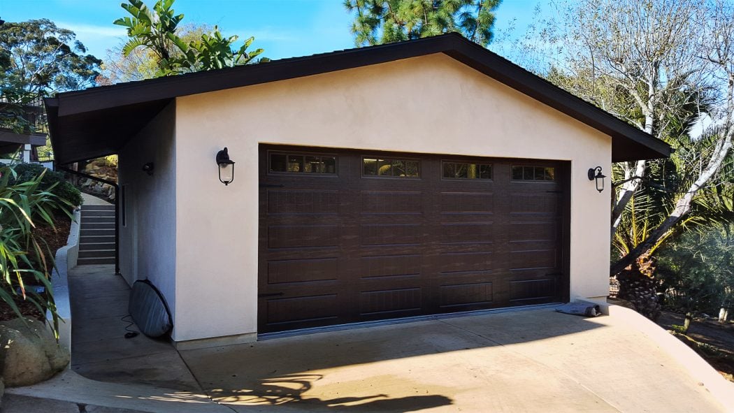The two car stucco garage houses outdoor sports items for the owners.