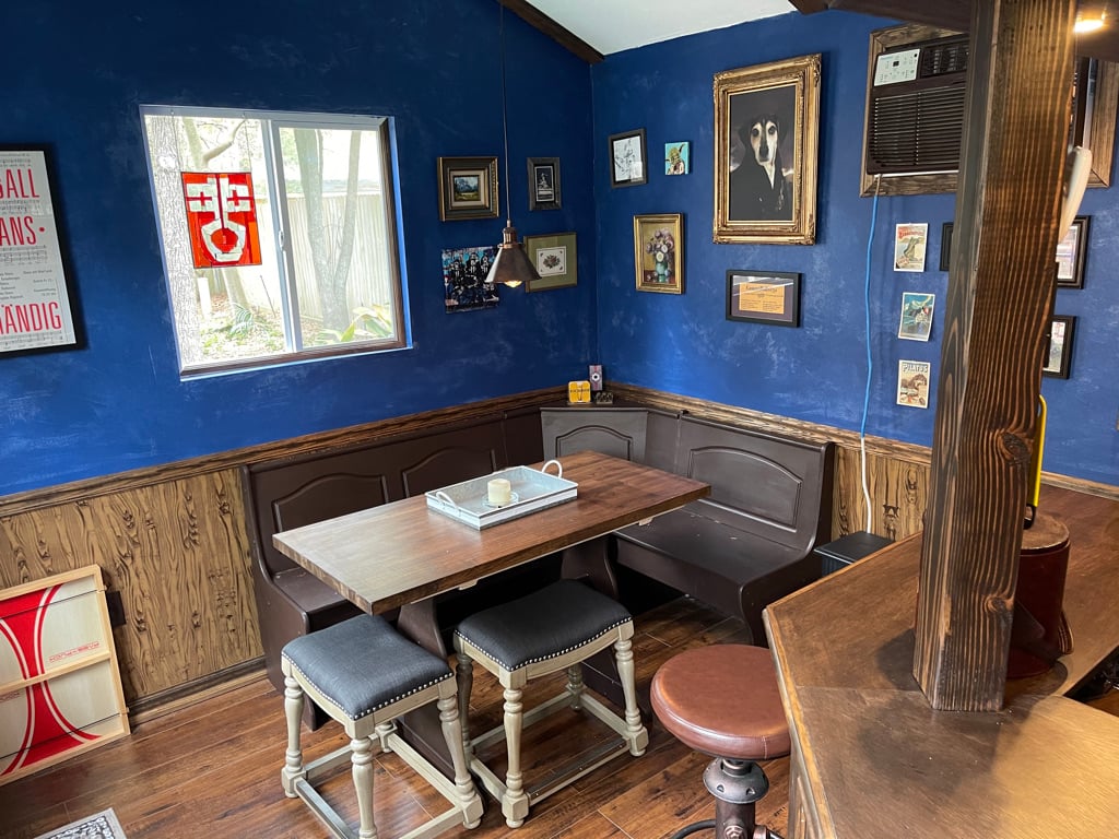 The interior of the perfect pub shed, decorated with old world art and wooden furniture