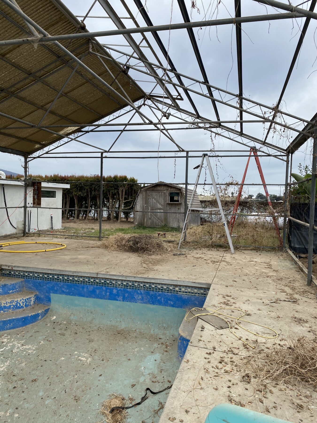 The previous Tuff Shed barn and the pool in the backyard of the farm.