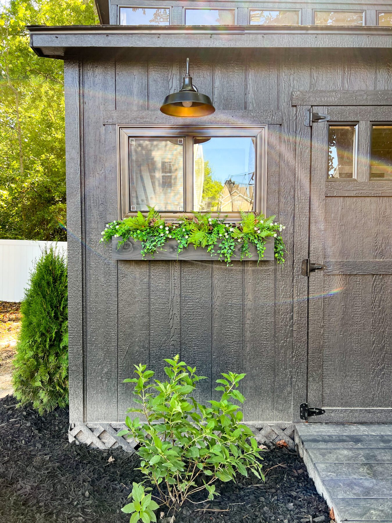 More exterior details of the DIY workshop exterior, including custom window boxes.