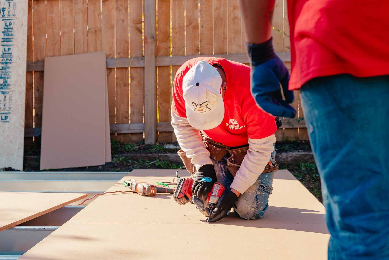 Tuff Shed installer working on the floor of the urban barn