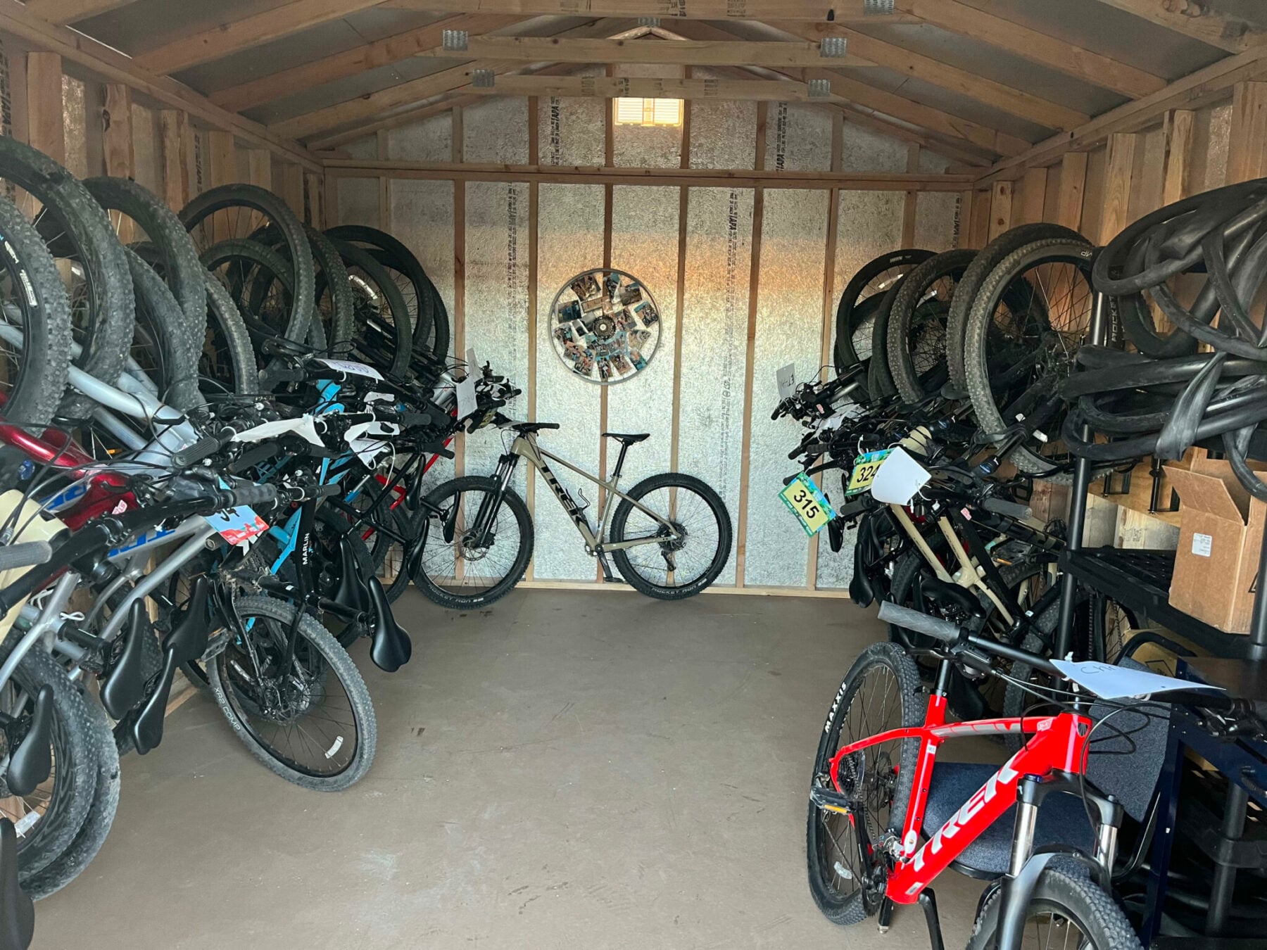 Interior of bike shed with many hanging bikes