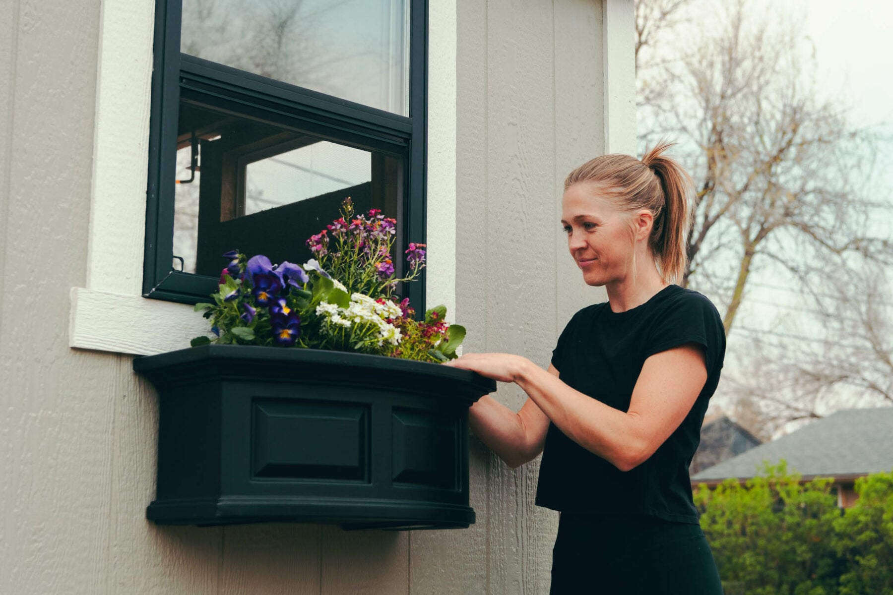 Karen potting flowers in new window boxes