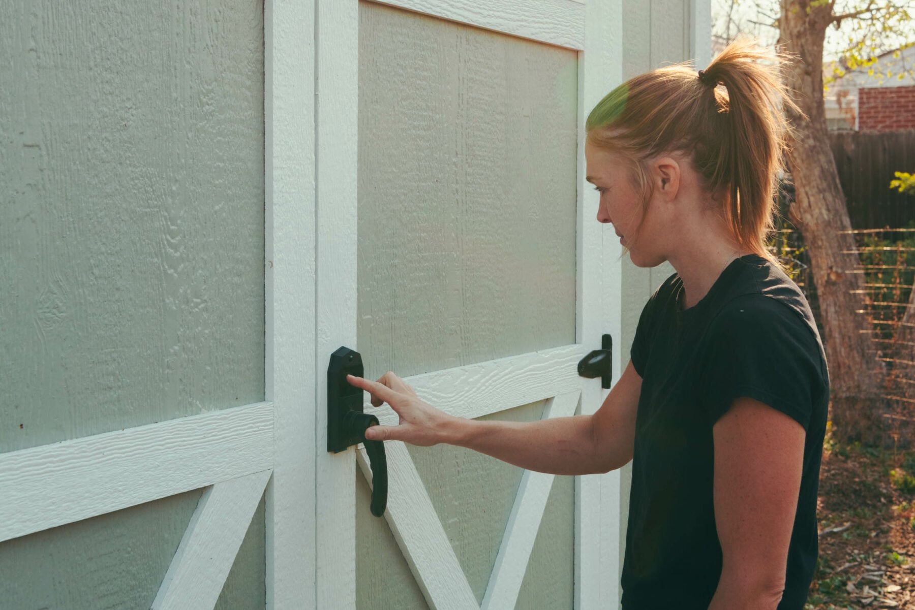 Karen using the keyless door handle on her urban barn