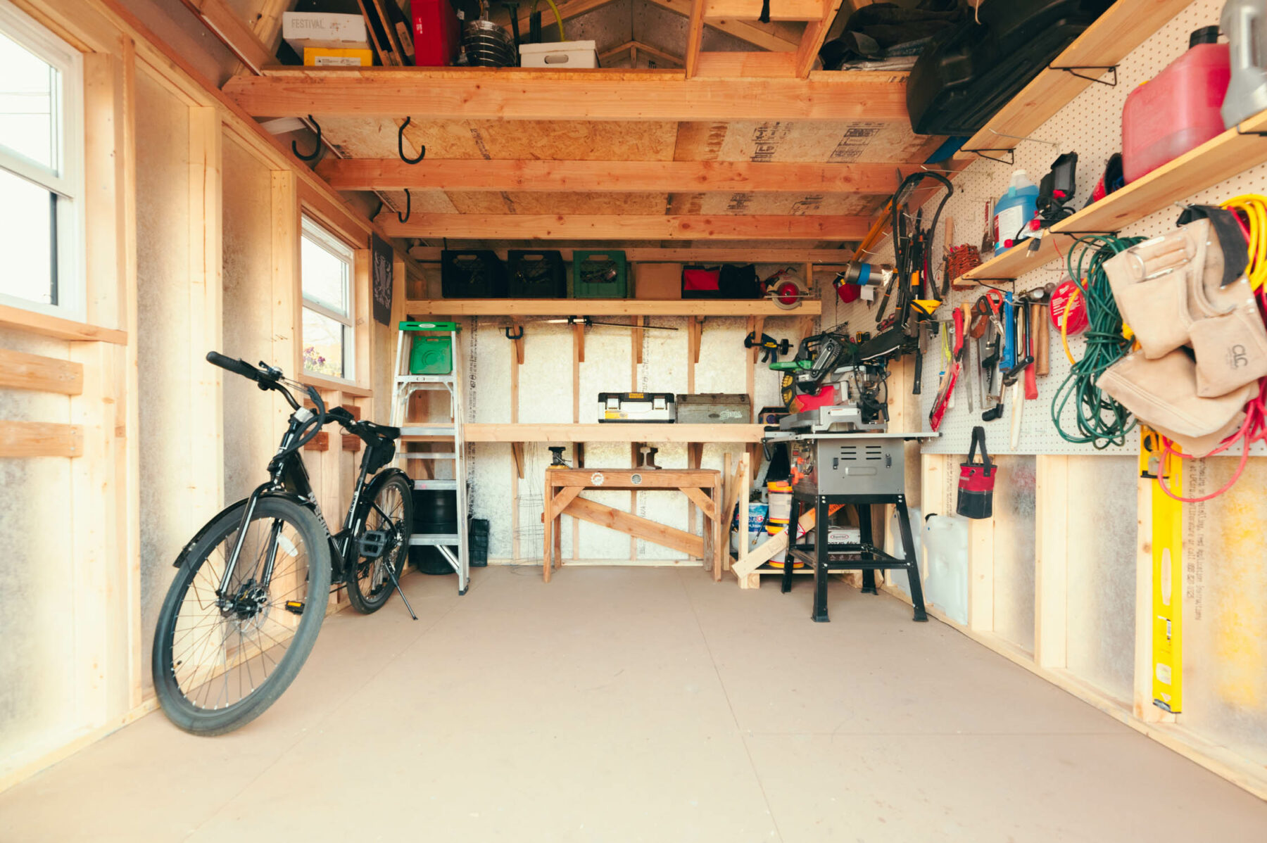 Interior of an urban barn organized with tools and bike